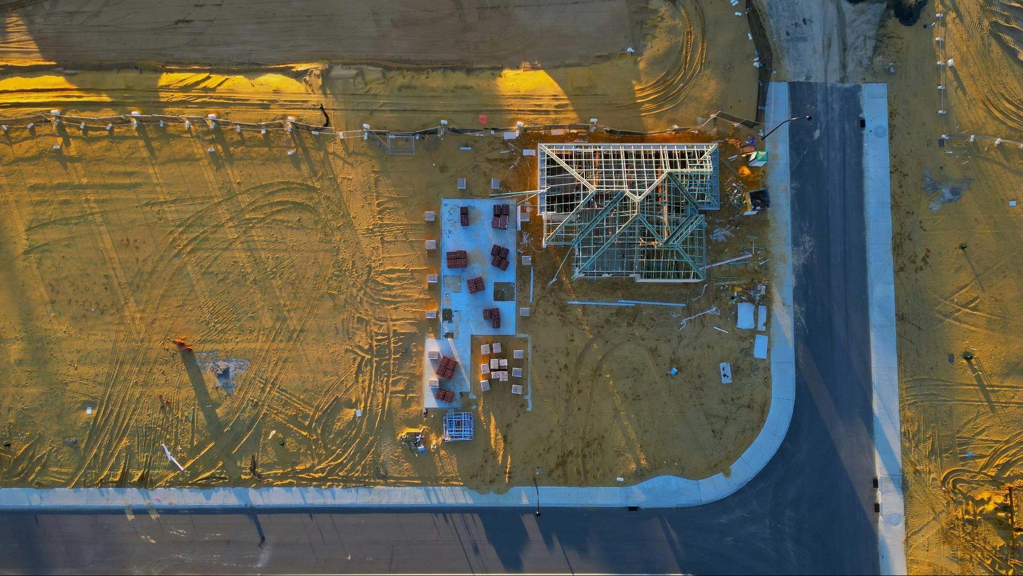 A drone conducting a safety inspection over a construction site