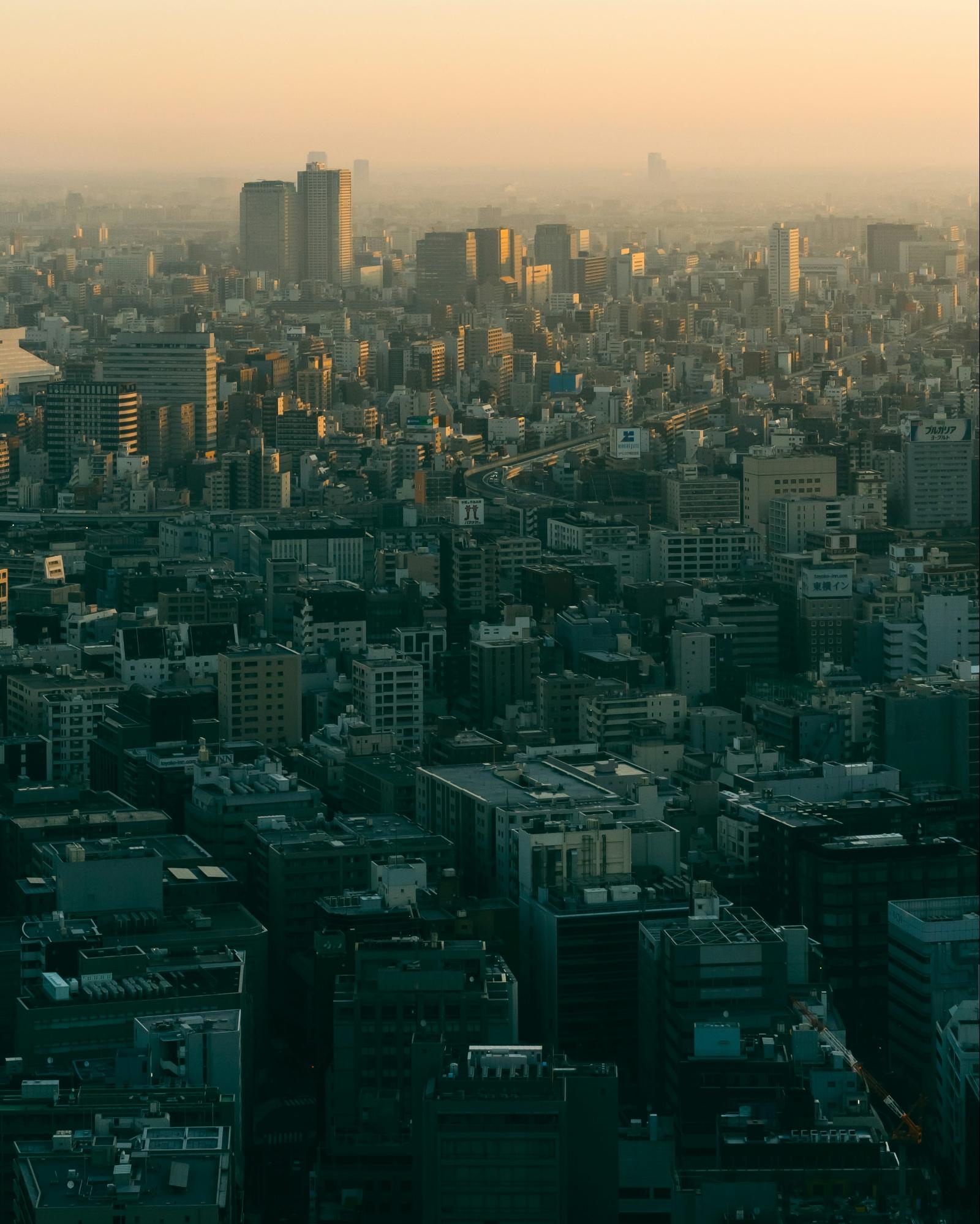 Drone capturing data over a cityscape at sunset