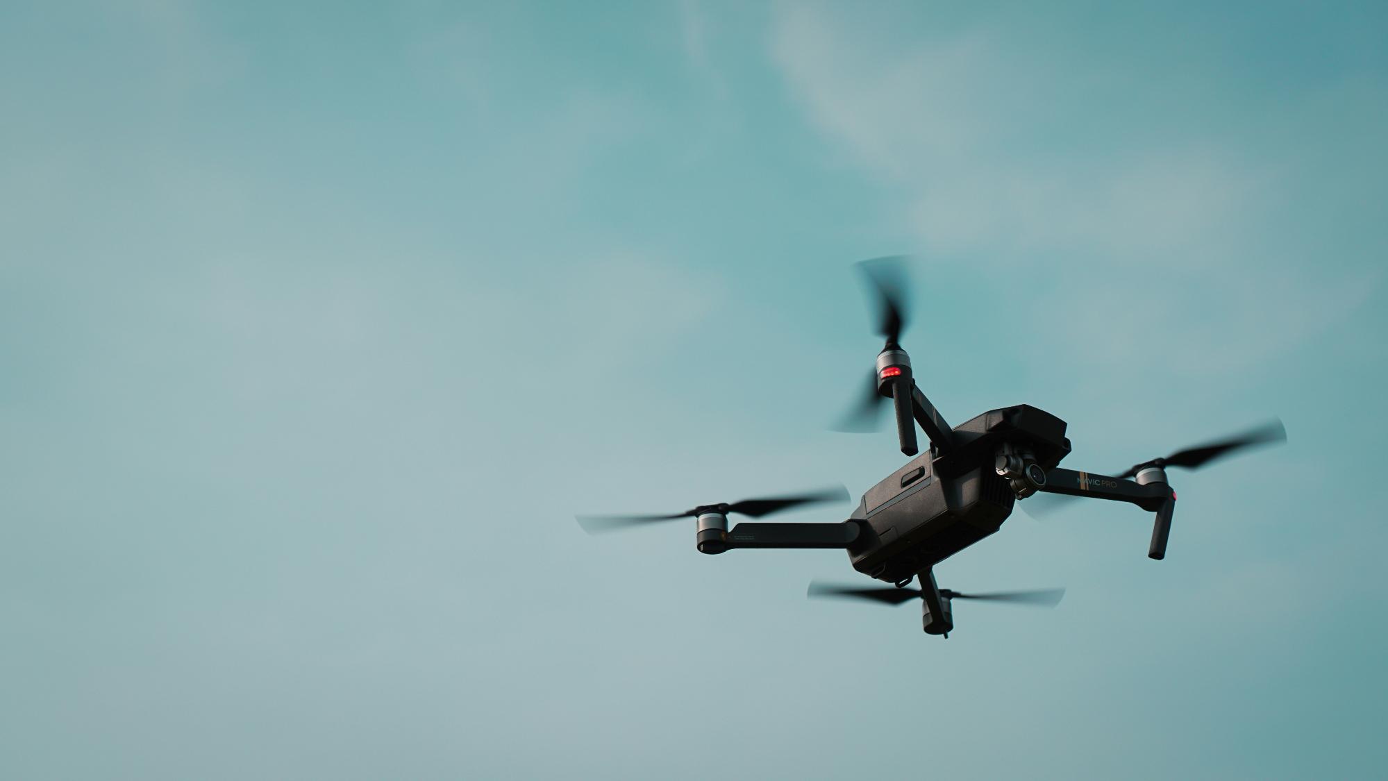 A drone inspecting a large utility structure for cost-efficient data gathering