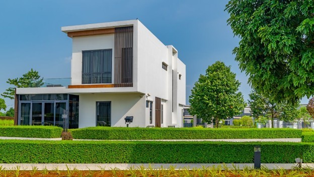 A white house with a lawn and trees