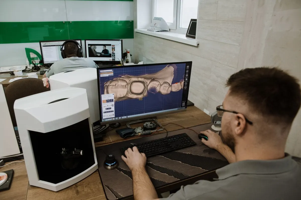 Person working at a computer creating and reviewing 3D digital models